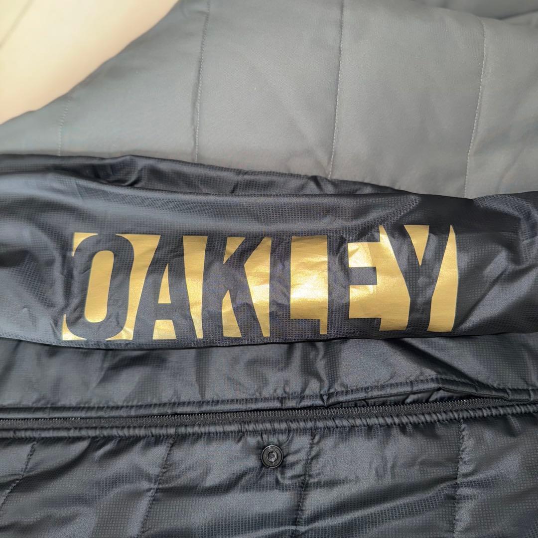 最終値下げ　美品　OAKLEY ベンチコート背面刺繍ビッグサイズ　バッグロゴ　金